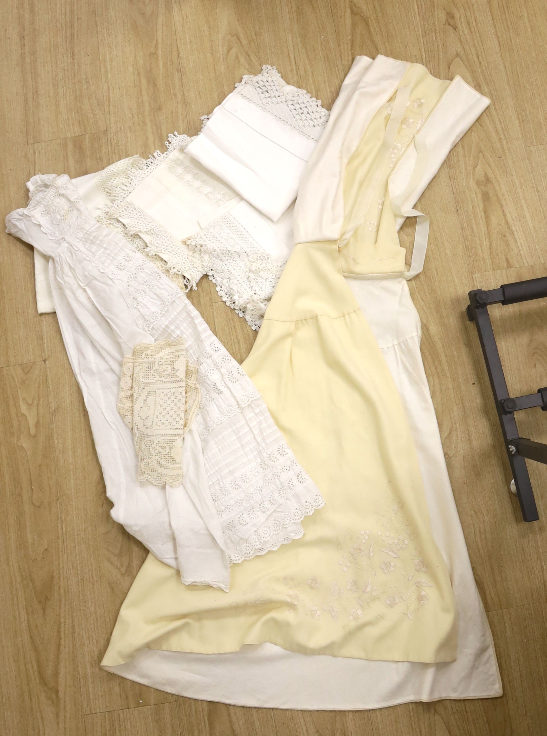 A 19th century embroidery anglais christening gown and nun's veiling cape, together with a small collection of tablecloths, etc